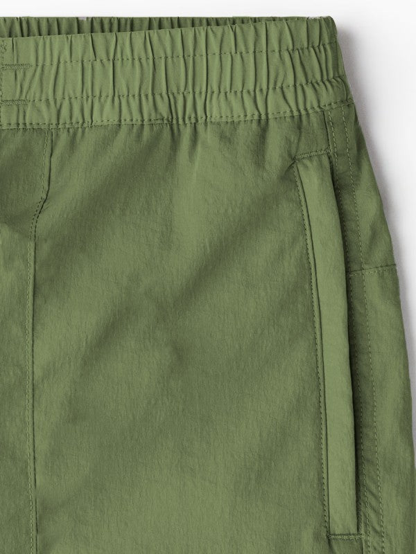 Olive cargo pants close-up: elastic waistband and reinforced hem stitching