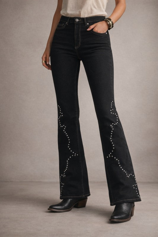Black bootcut jeans with studded accents along the lower legs