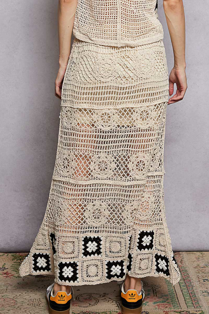Natural maxi crochet skirt with ruffled waist and black granny square border at hem