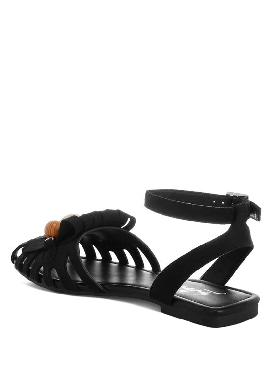 Black cutwork flat sandals with ankle strap and multi-color bead fringe detail