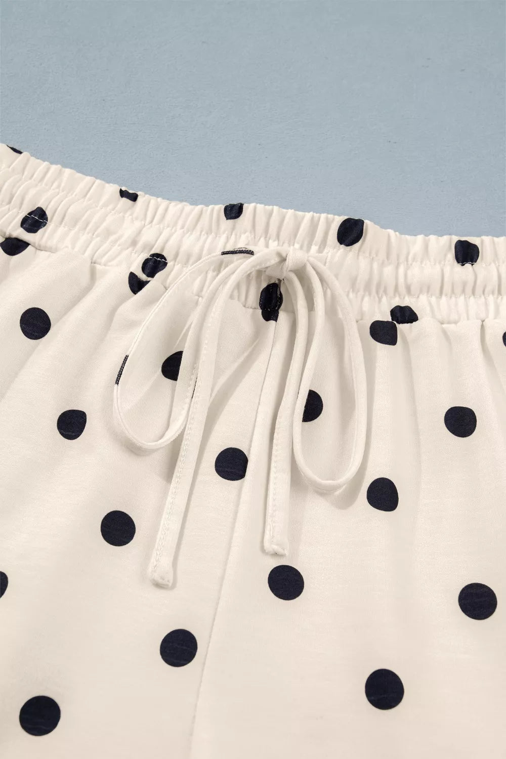 Cream polka dot drawstring shorts with elastic waistband