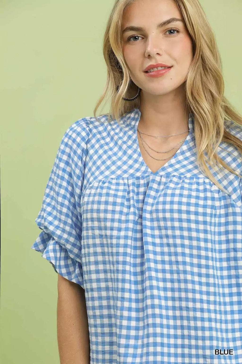 Blue gingham blouse close-up: square neckline with ruffled yoke and sleeve cuffs