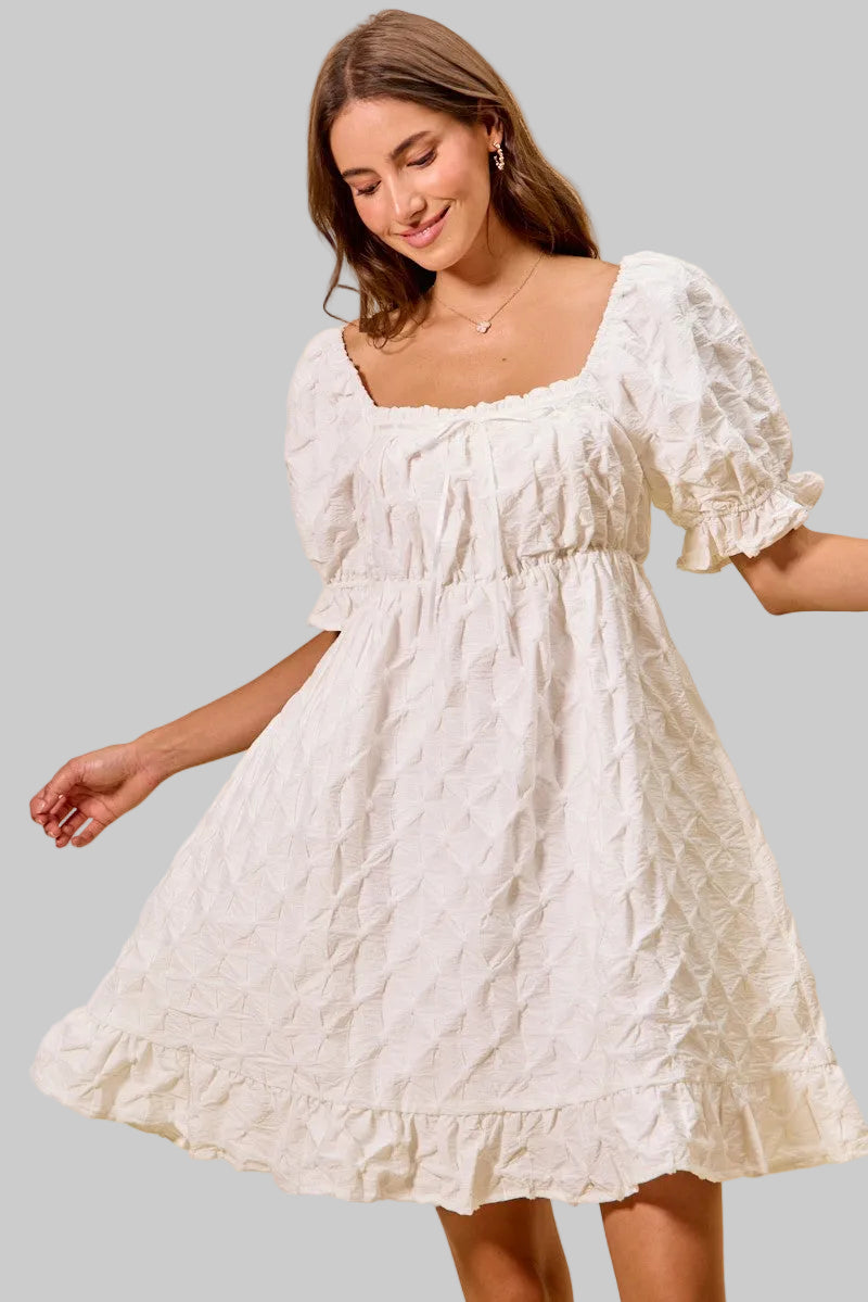 Off-white mini dress with ruched bust and textured woven pattern, ruffled hem