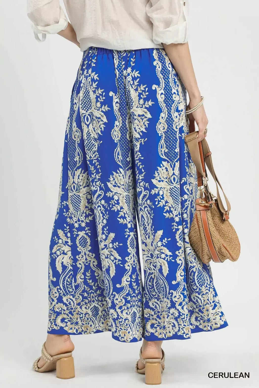 Blue border print wide-leg pants with gathered waist and full, swaying legs