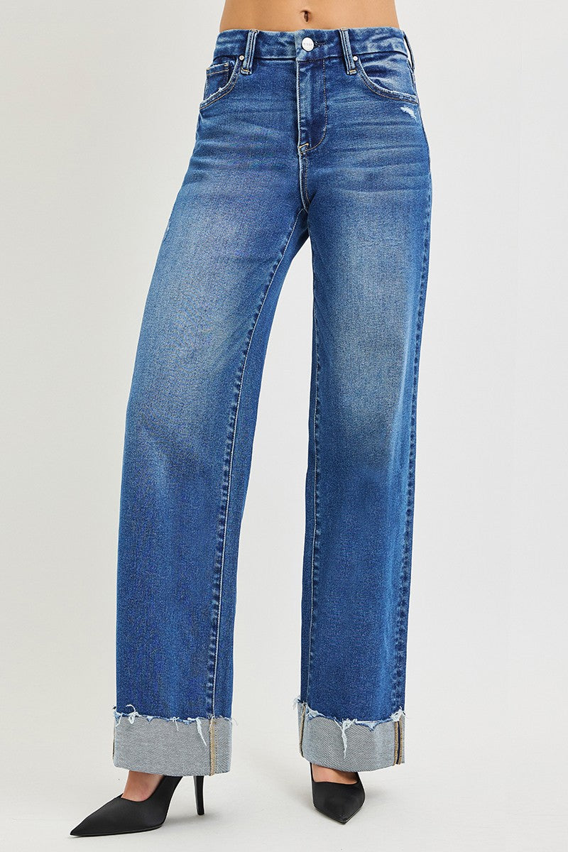 Front view: medium wash blue high-rise wide-leg jeans with cuffed, frayed hems