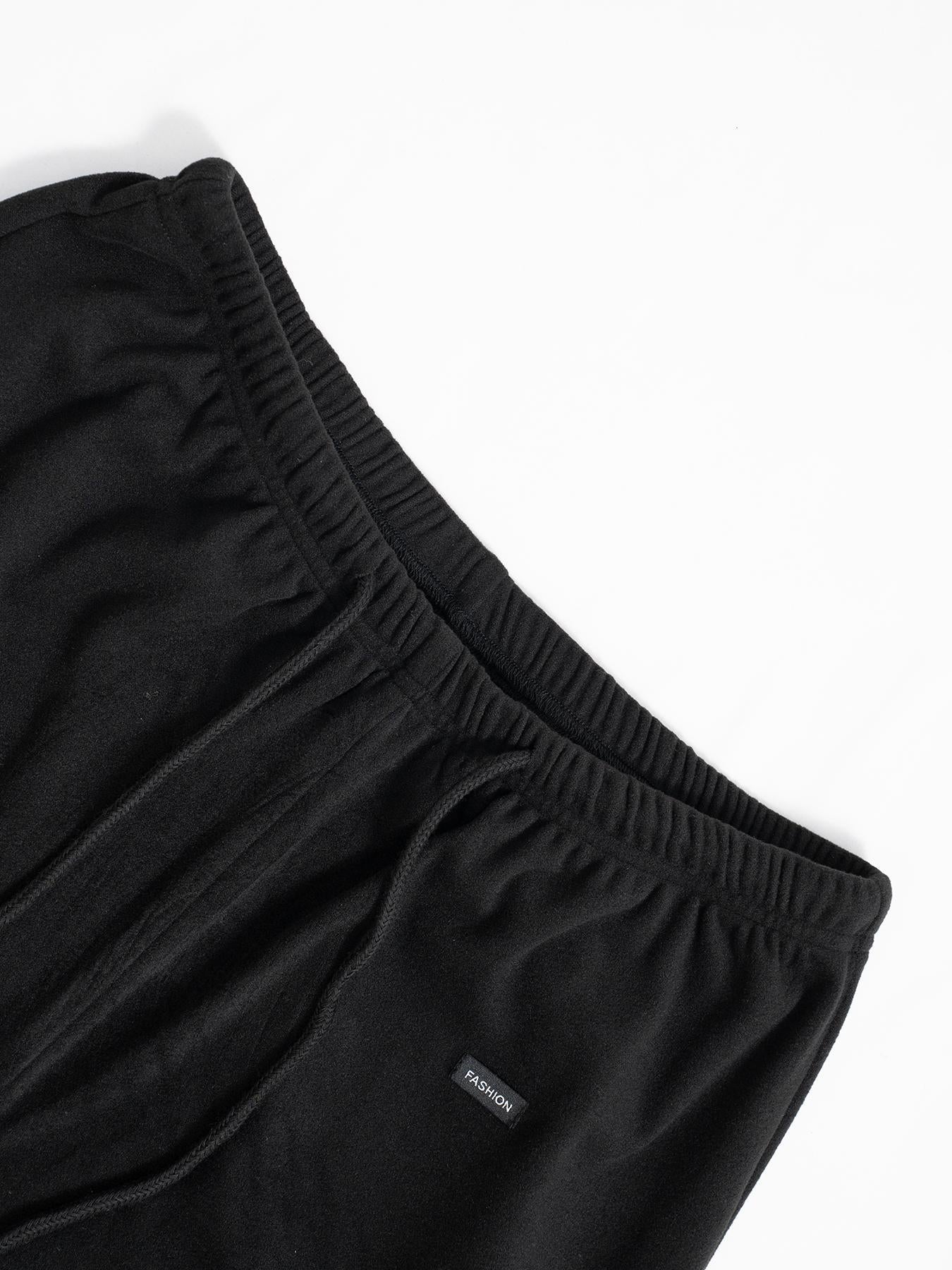 Black relaxed fit drawstring pants, elastic waistband and front tie detail
