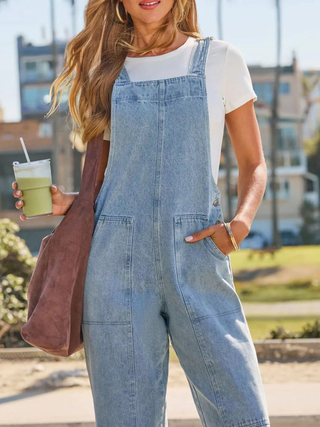 Light blue denim overalls with front bib, two patch pockets, wide straight legs