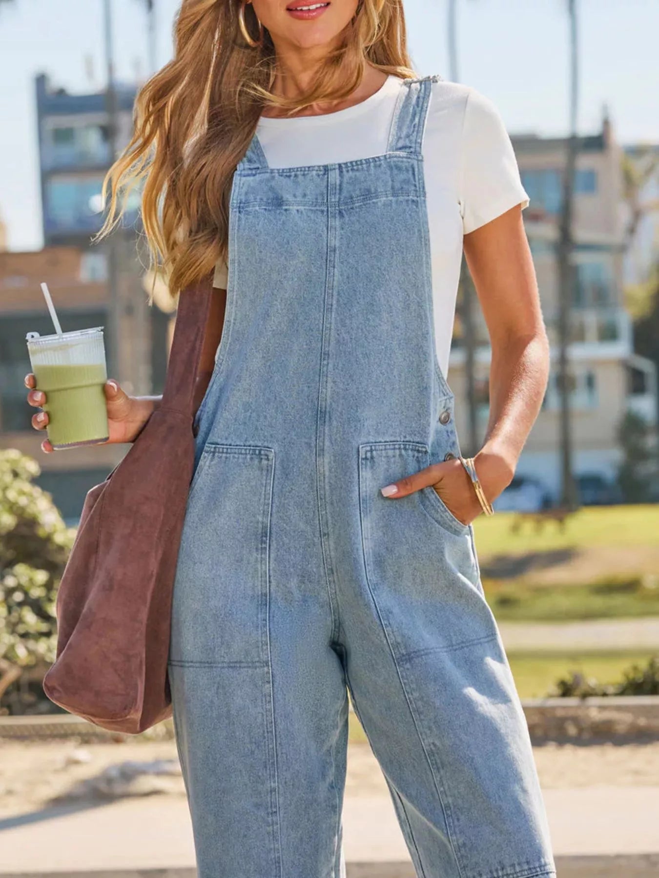 Light blue denim overalls with front bib, two patch pockets, wide straight legs