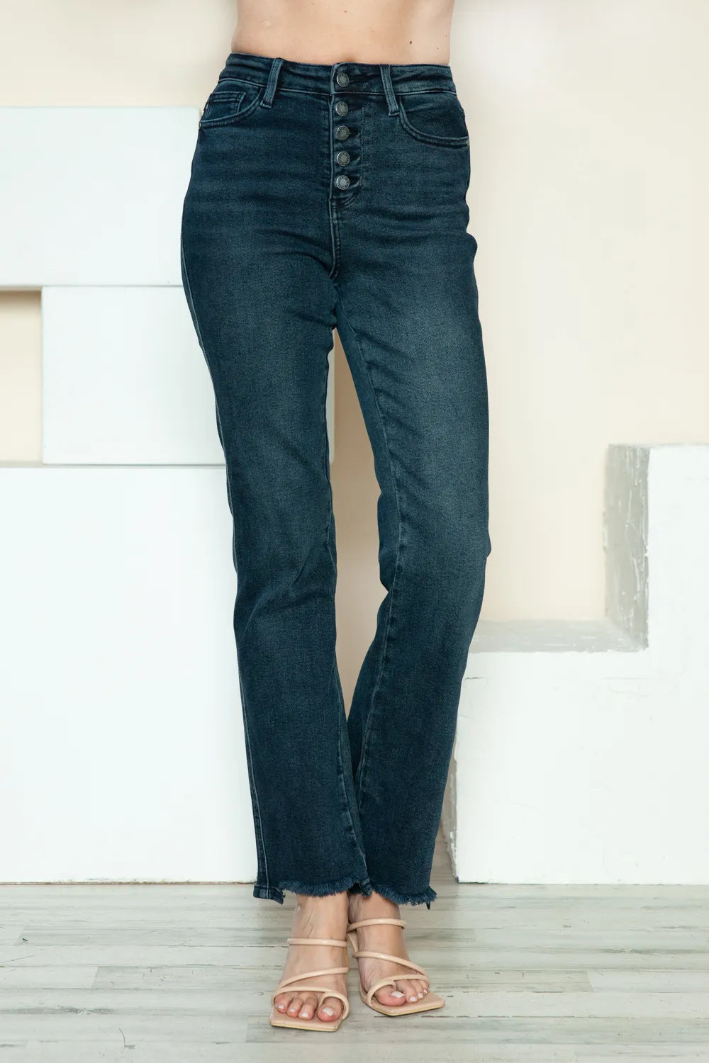 Dark blue straight jeans with front button-fly and frayed raw ankle hem