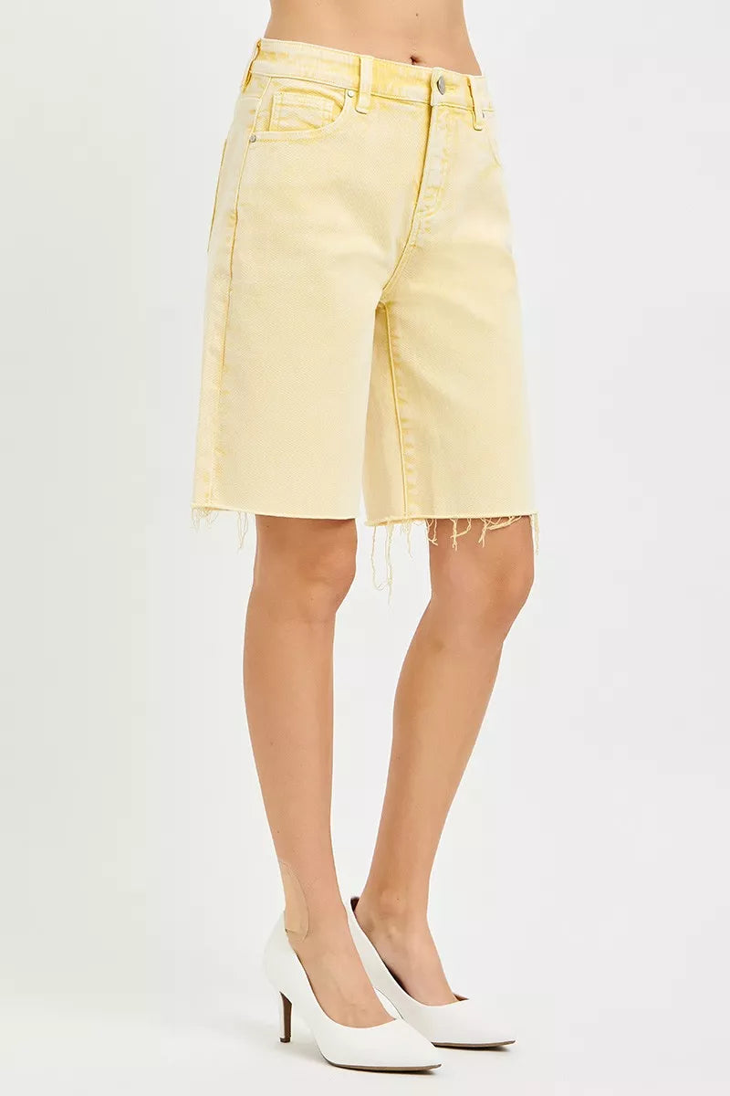Back view: banana yellow bermuda shorts with belt loops and frayed hem