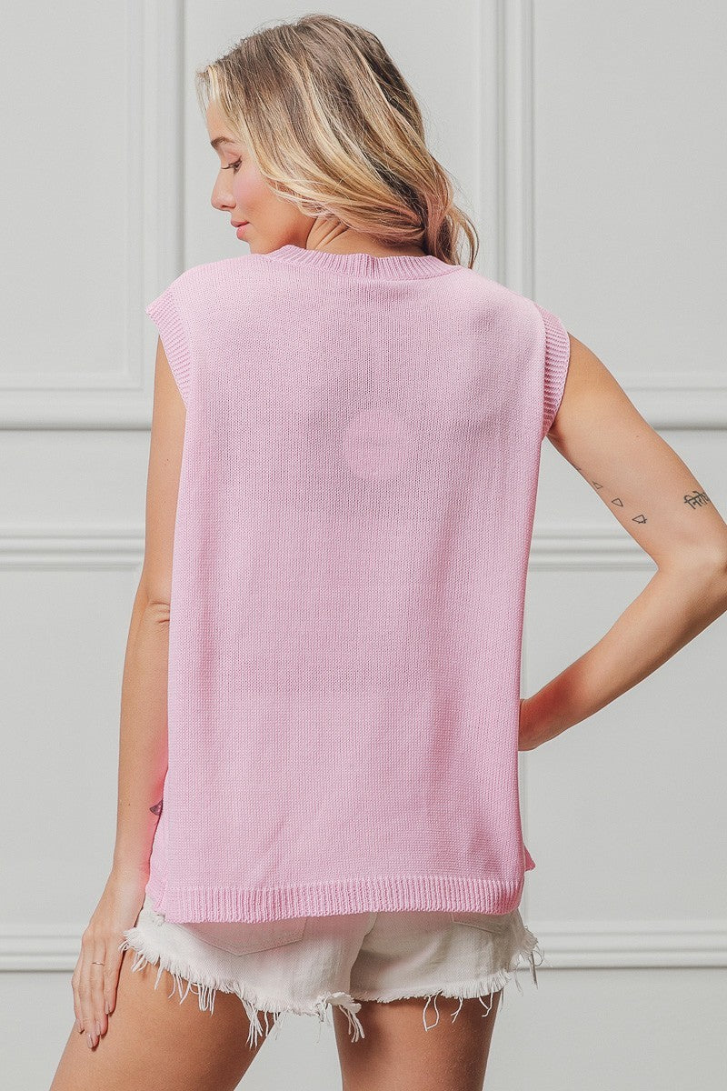 Back view of pink sleeveless knit top with ribbed armholes and hem