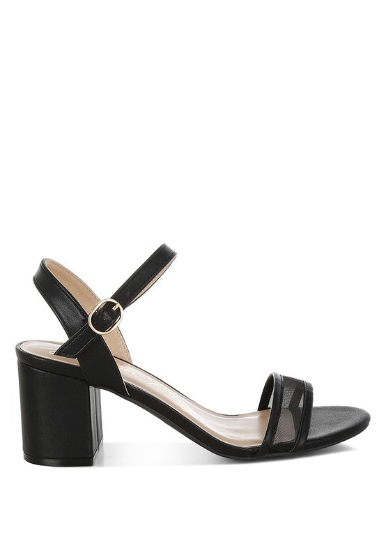 Black block-heel sandal showing side profile, pin buckle, and mesh straps