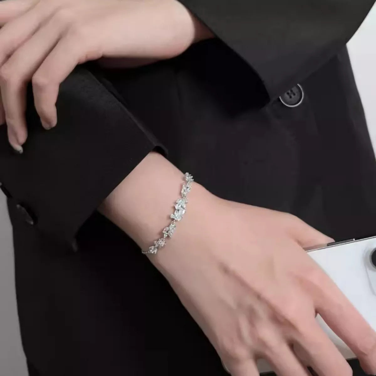 Sterling silver Wisteria zircon bracelet on wrist, curved stone links