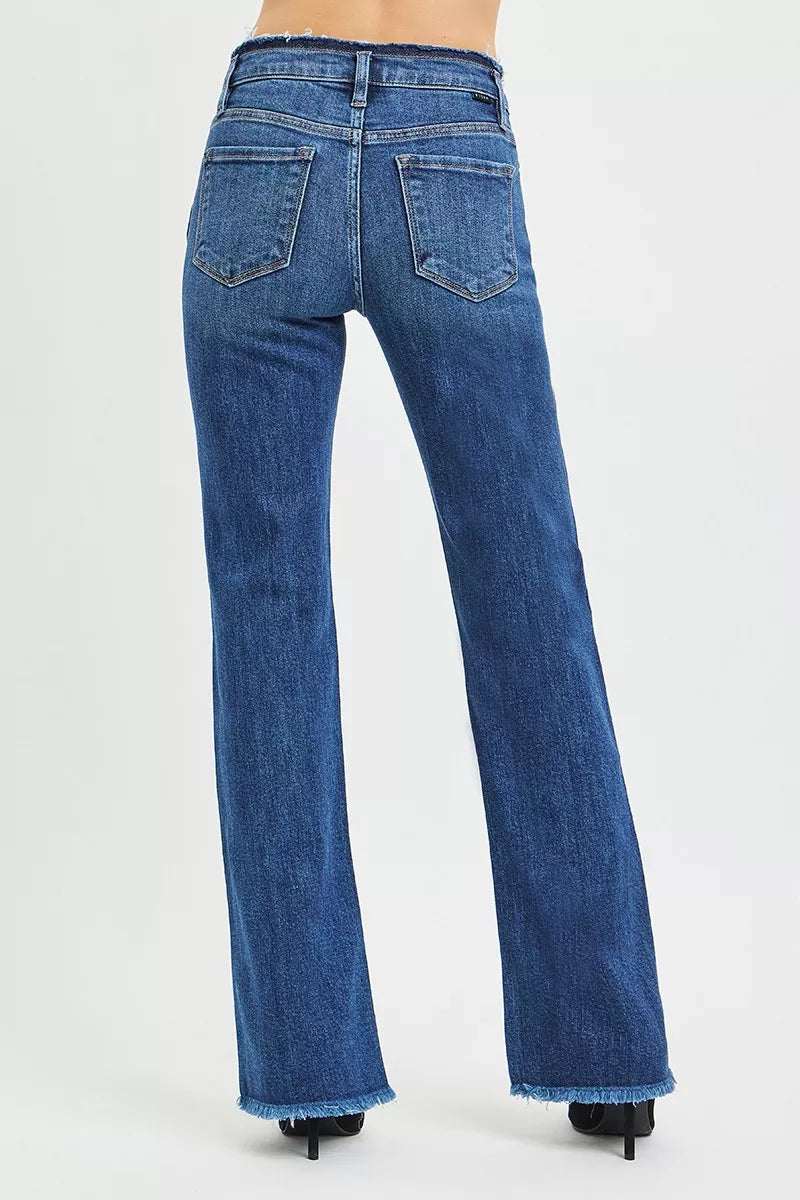 Back view dark blue bootcut jeans with stitched back pockets and frayed hems