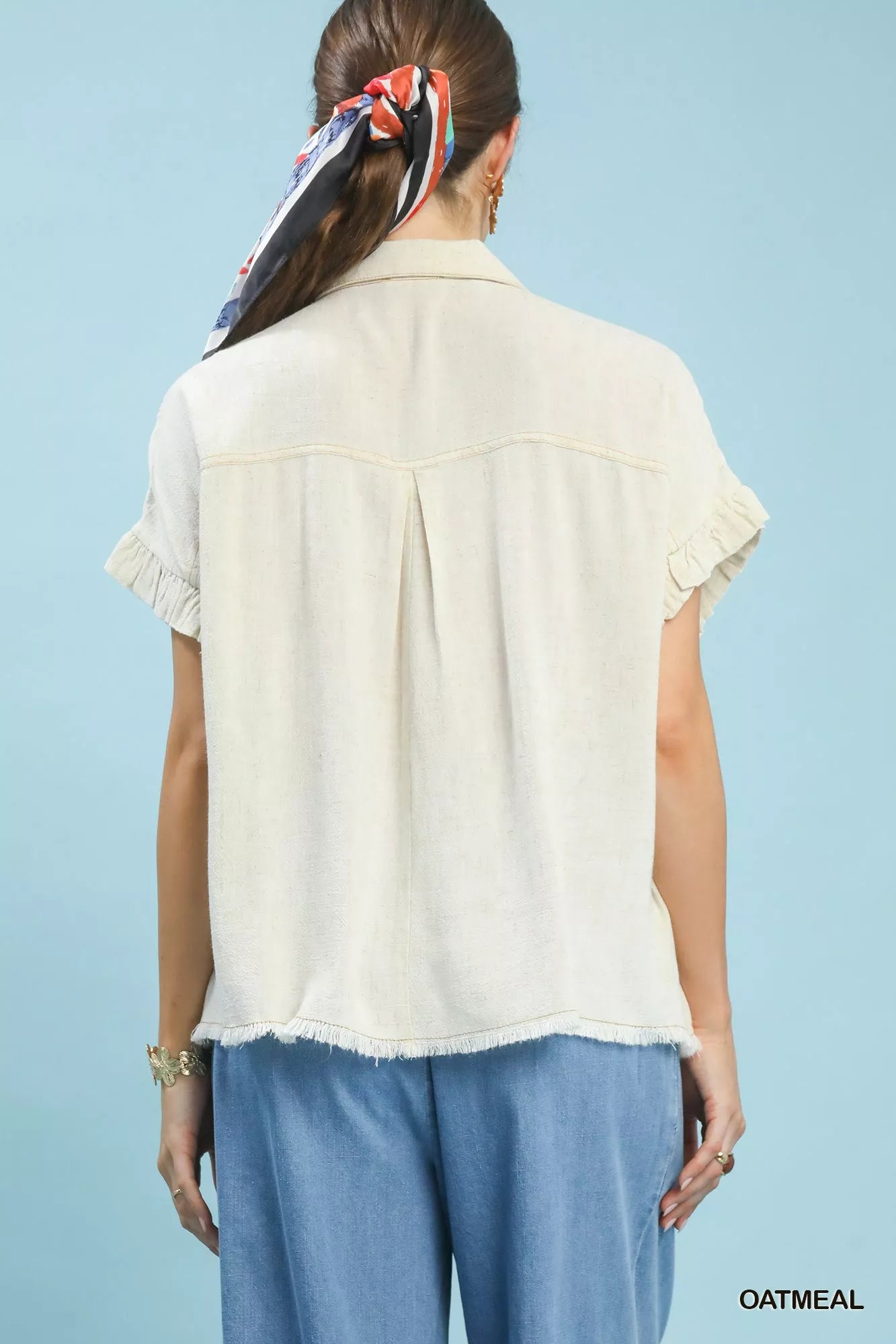 Back view of oatmeal smocked linen-blend shirt with short sleeves and button placket