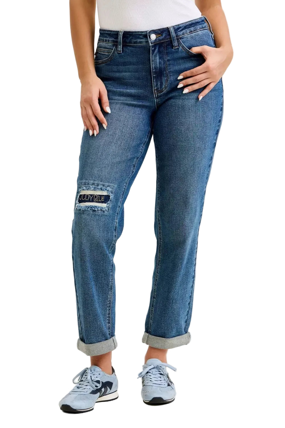 Medium blue mid-rise boyfriend jeans with embroidered repair patch at knee