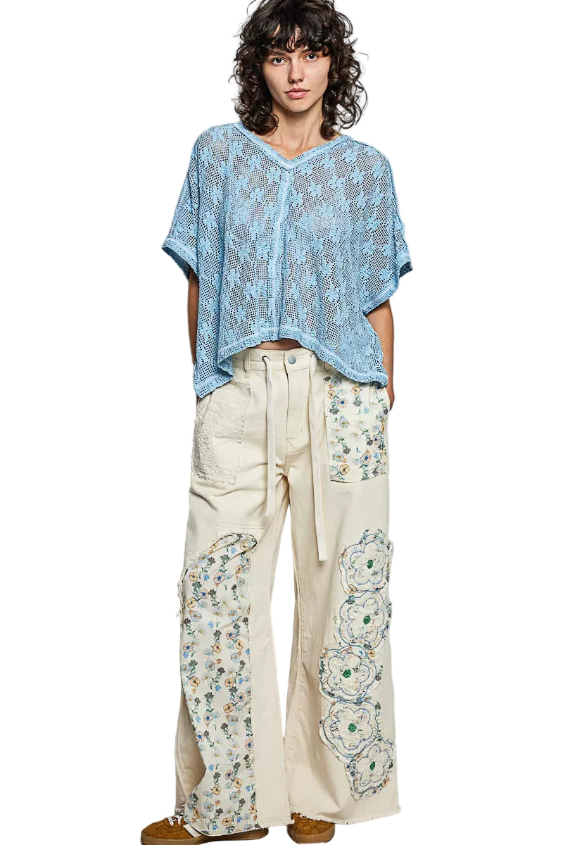 Blue crochet lace short sleeve top with V-neck and loose poncho-like silhouette
