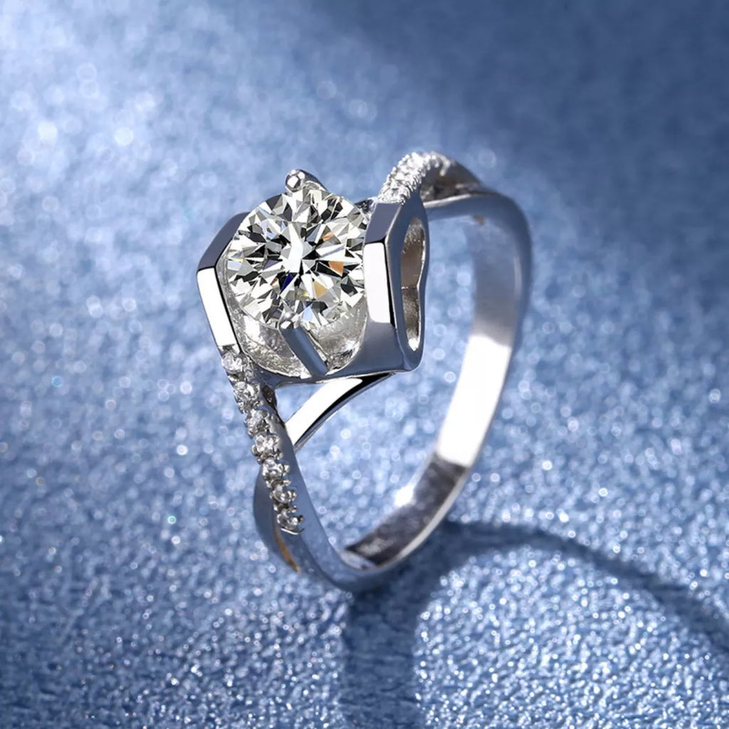 Sterling silver moissanite ring with round center stone and pavé set band