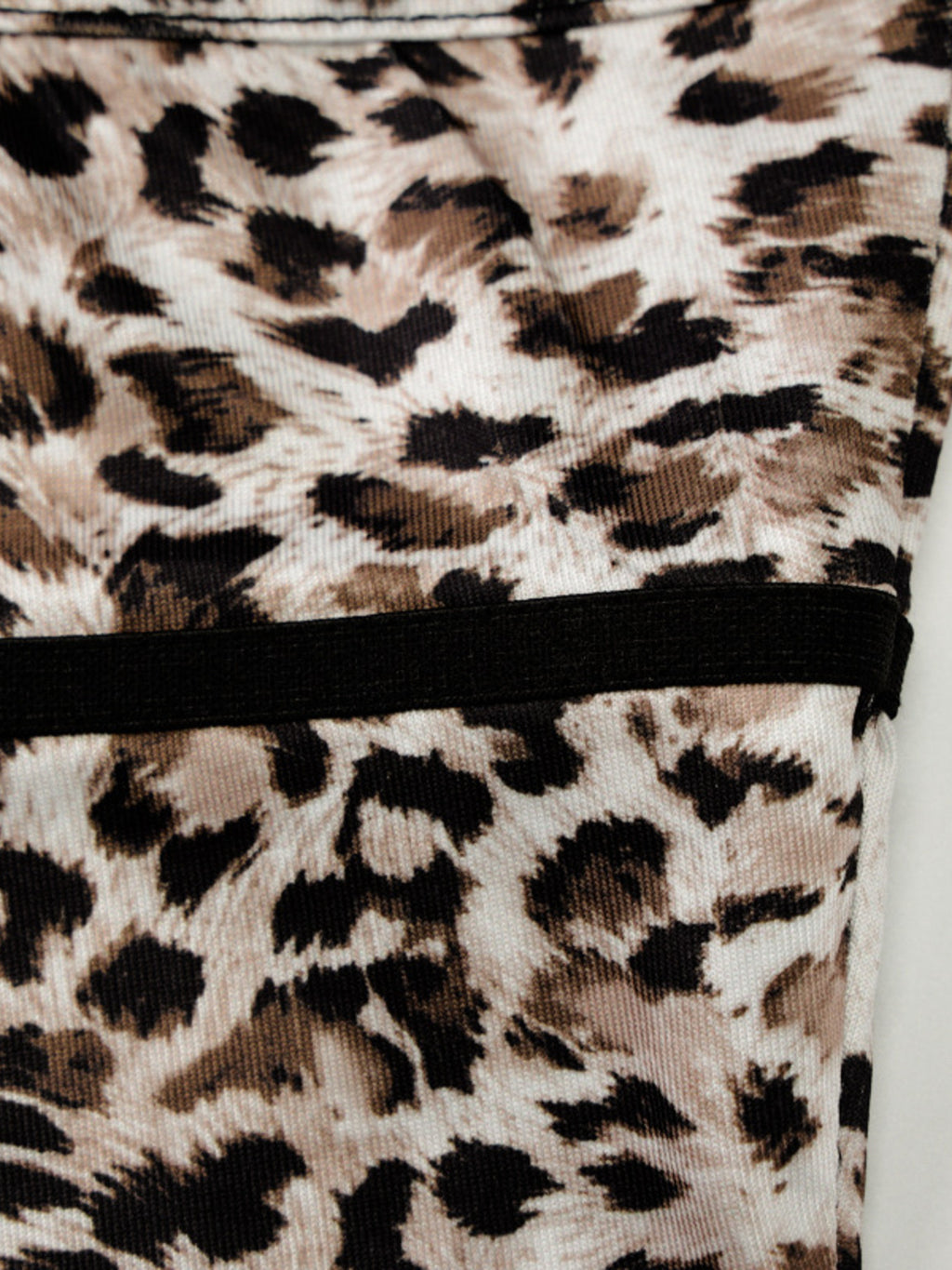 Leopard print cami with black lace trim along the bottom hem