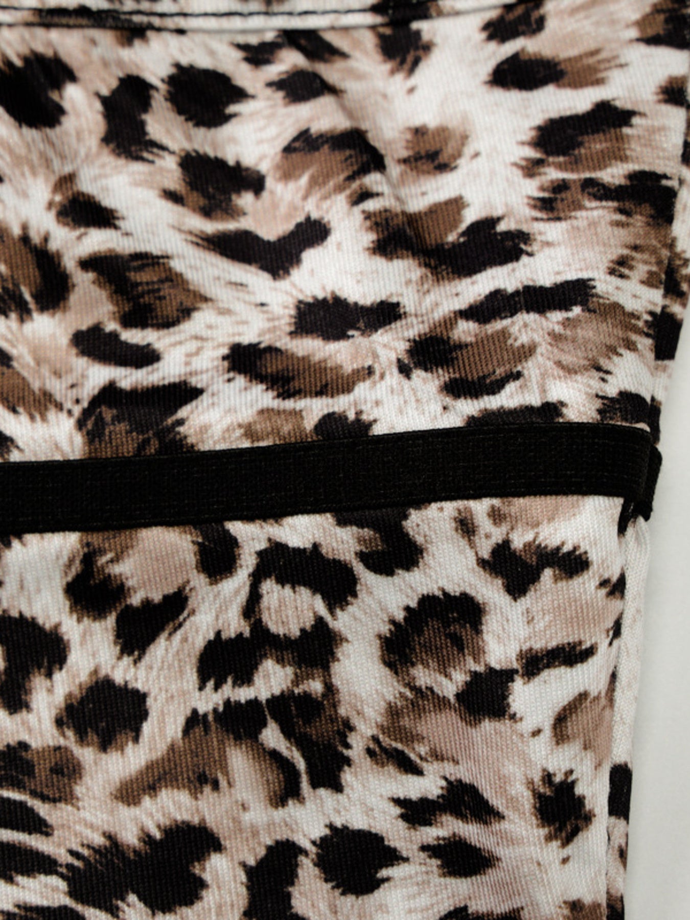 Leopard print cami with black lace trim along the bottom hem