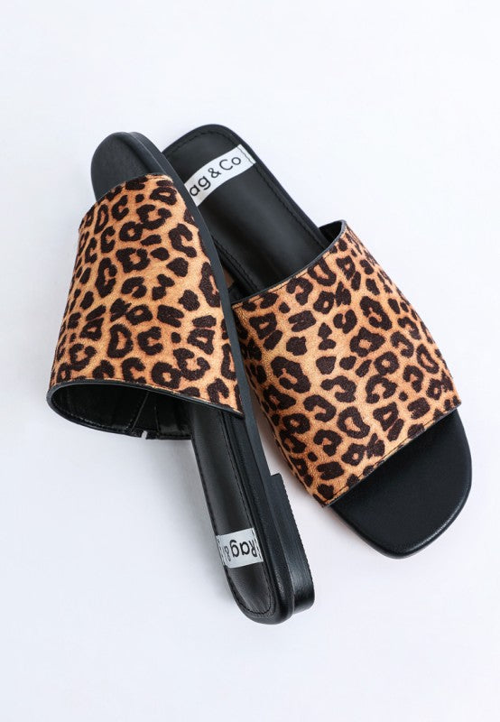 Leopard print slide flats with black footbed and cushioned-looking insole