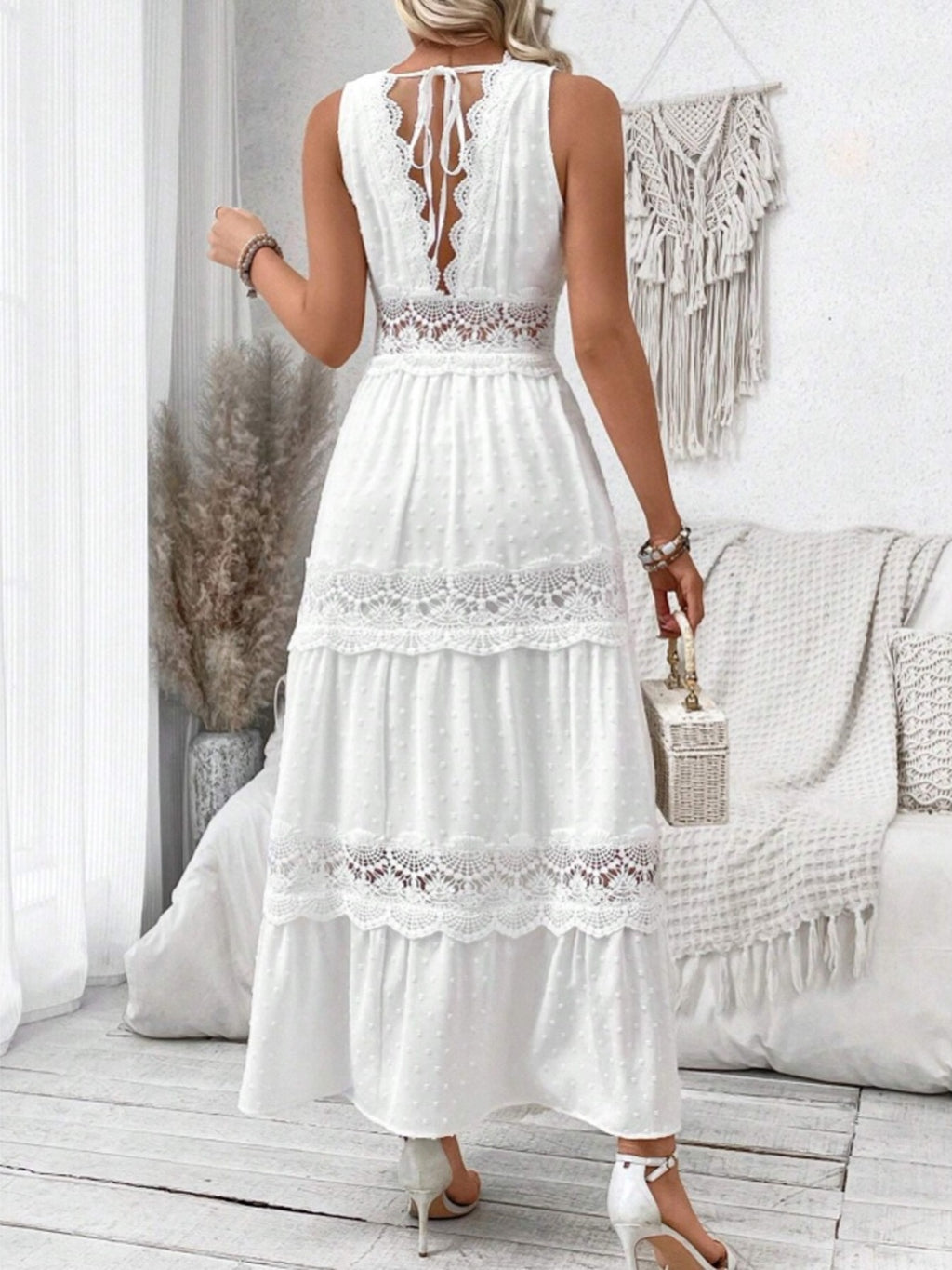 Back view of white sleeveless maxi dress with lace trim and tied spaghetti straps