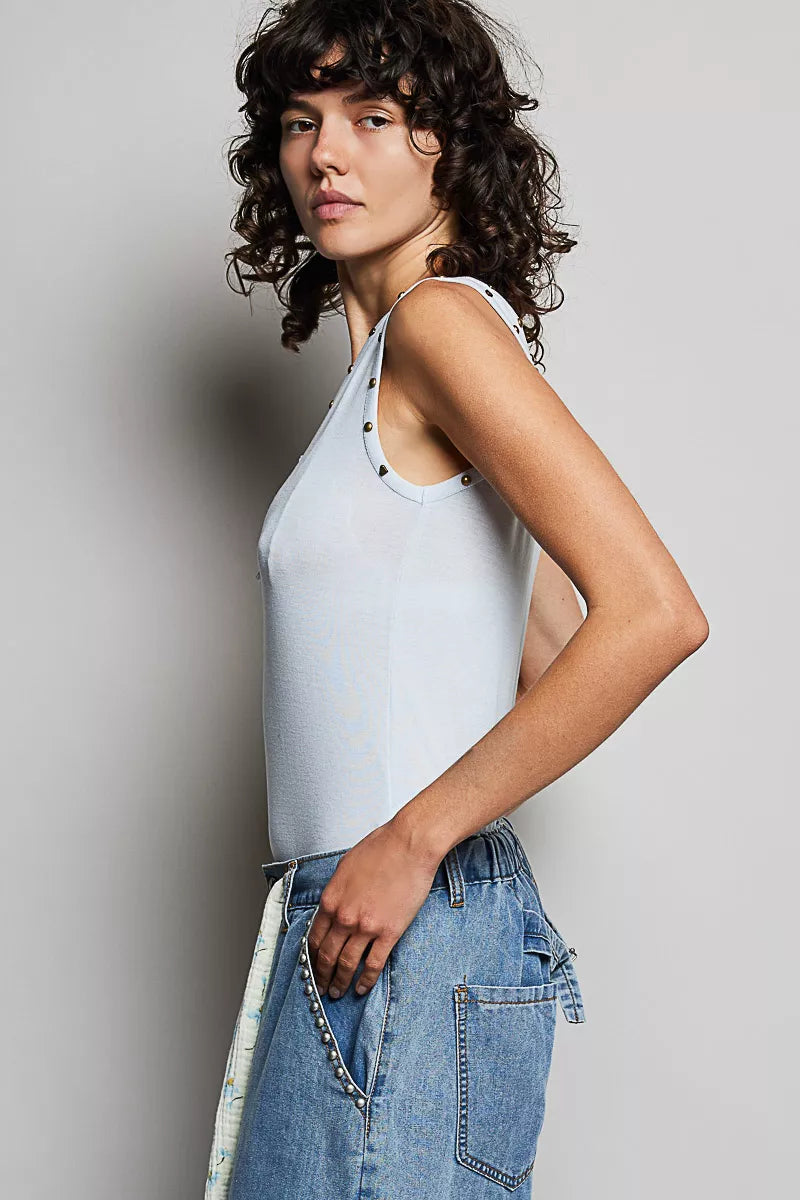 Side view of button-front tank with studded V-neck trim, sleeveless
