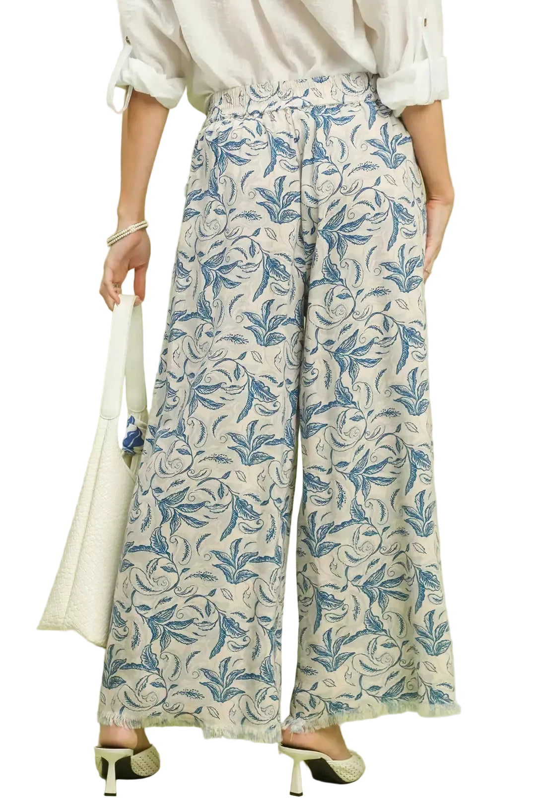 Angled view linen wide-leg pants with ocean blue botanical print and raw hem