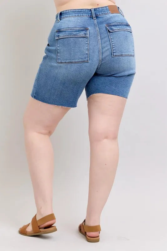 Back view: mid-rise denim bermuda shorts with flap back pockets, plus size