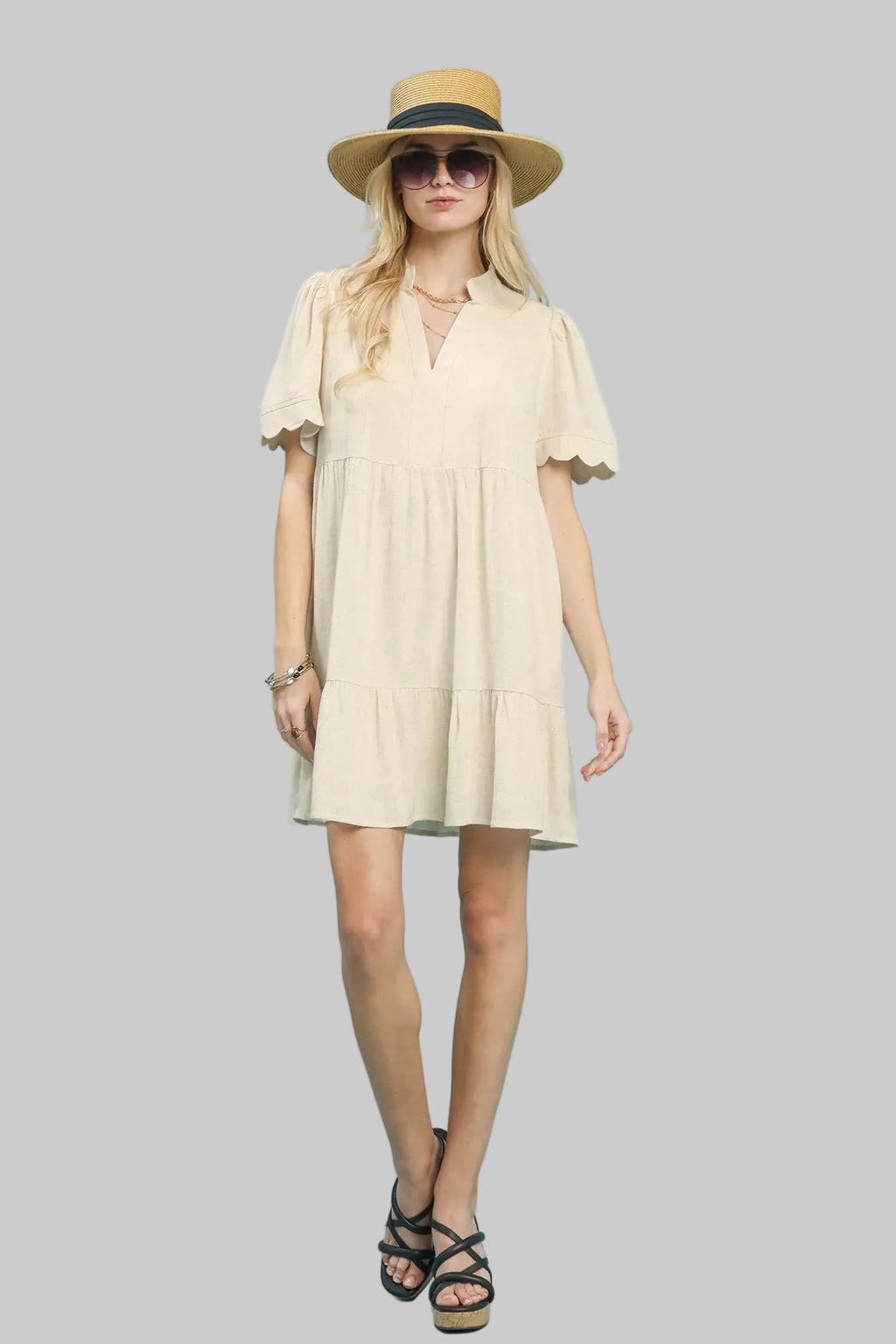 Full view oatmeal linen babydoll dress with tiered skirt and scalloped sleeves