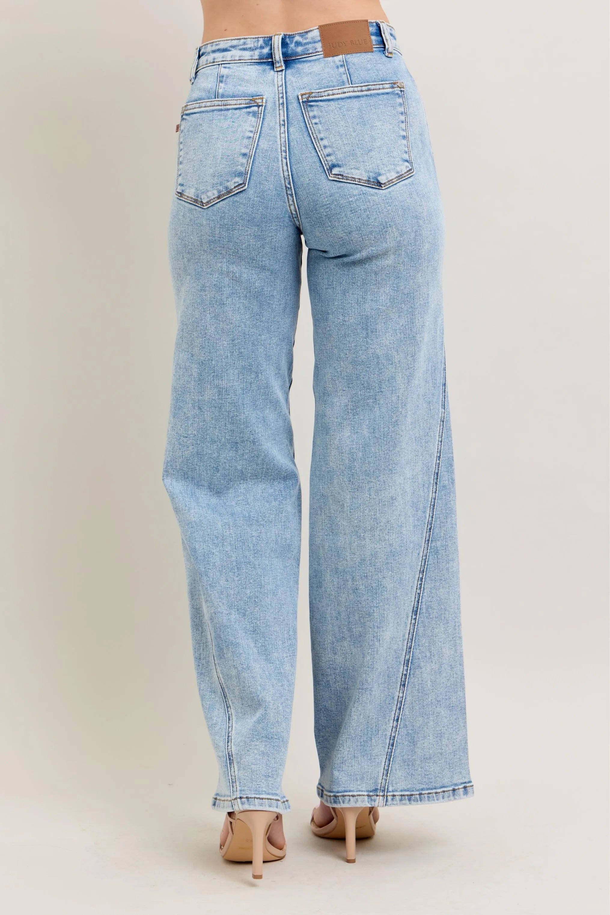 Light wash high-waist wide-leg jeans, back view with belt loops and center seam