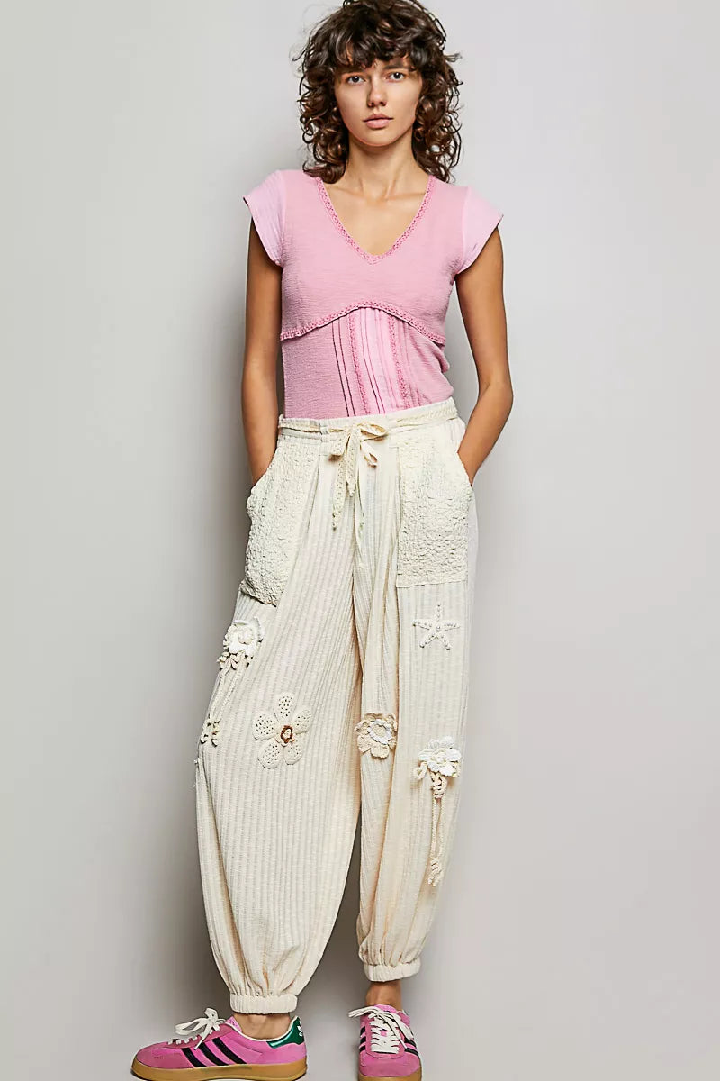 Soft pink V-neck short-sleeve knit top with lace detail at neckline