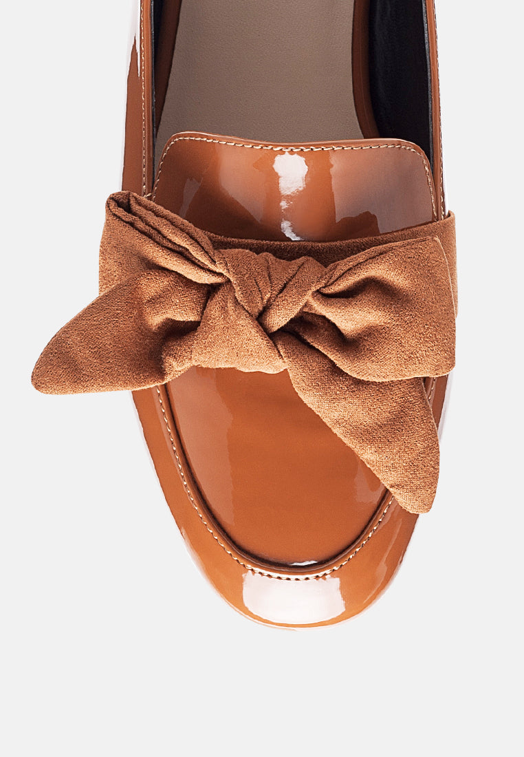 Tan loafer top view with suede bow tied at the opening and stitched trim