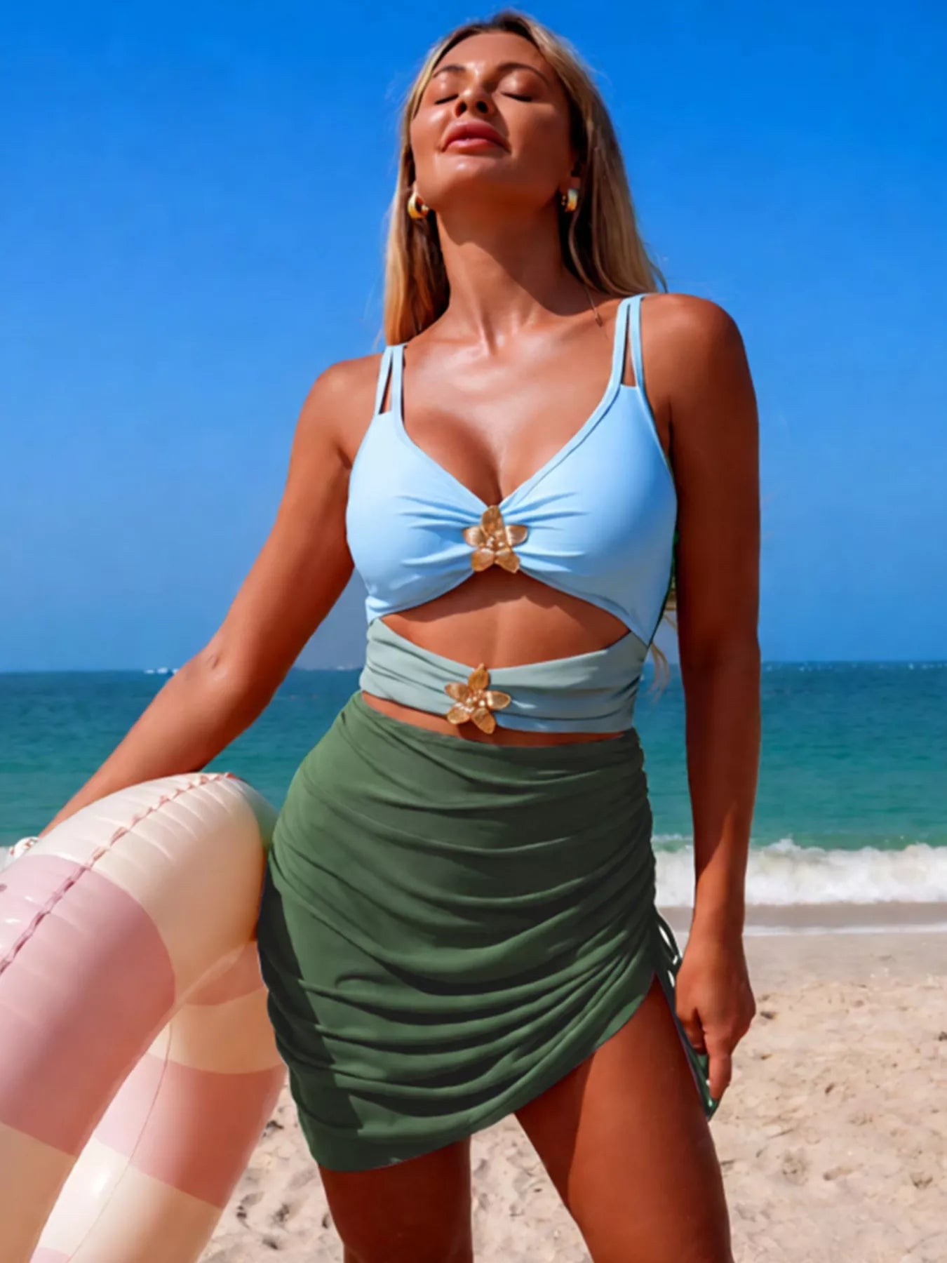Light blue and moss green cutout one-piece swimsuit with gold flower center detail