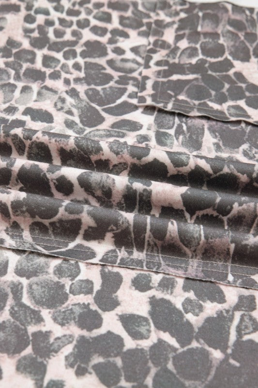 Leopard print fabric detail on khaki drawstring pants, showing seams and patch pocket edges