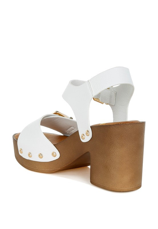 White leather clog sandals with dual gold buckle straps and tan platform heel