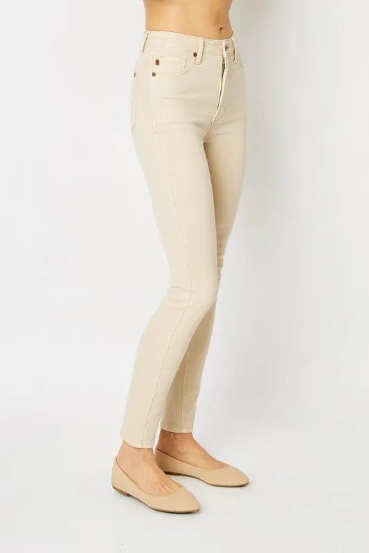 Bone skinny jeans on model, side view showing slim straight leg