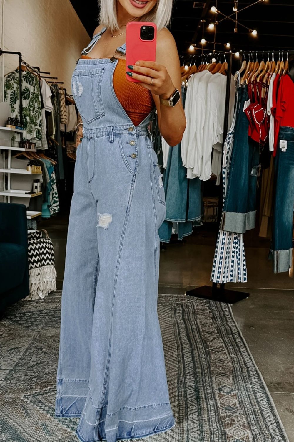 Light blue denim overalls with distressed bib and wide flared legs