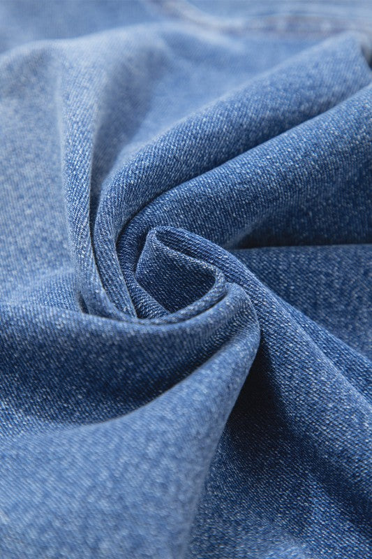 Denim fabric texture close-up on straight-leg jeans