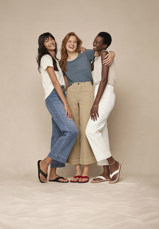 Perrys toe-post thong flats shown in multiple colors: black, red, and white