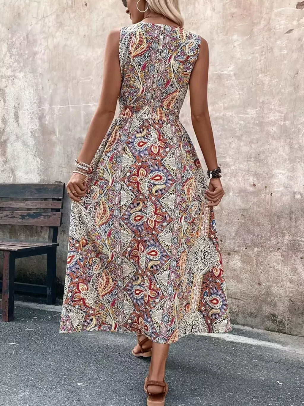 Back view of multicolor paisley sleeveless romper with long top, fitted waist seam