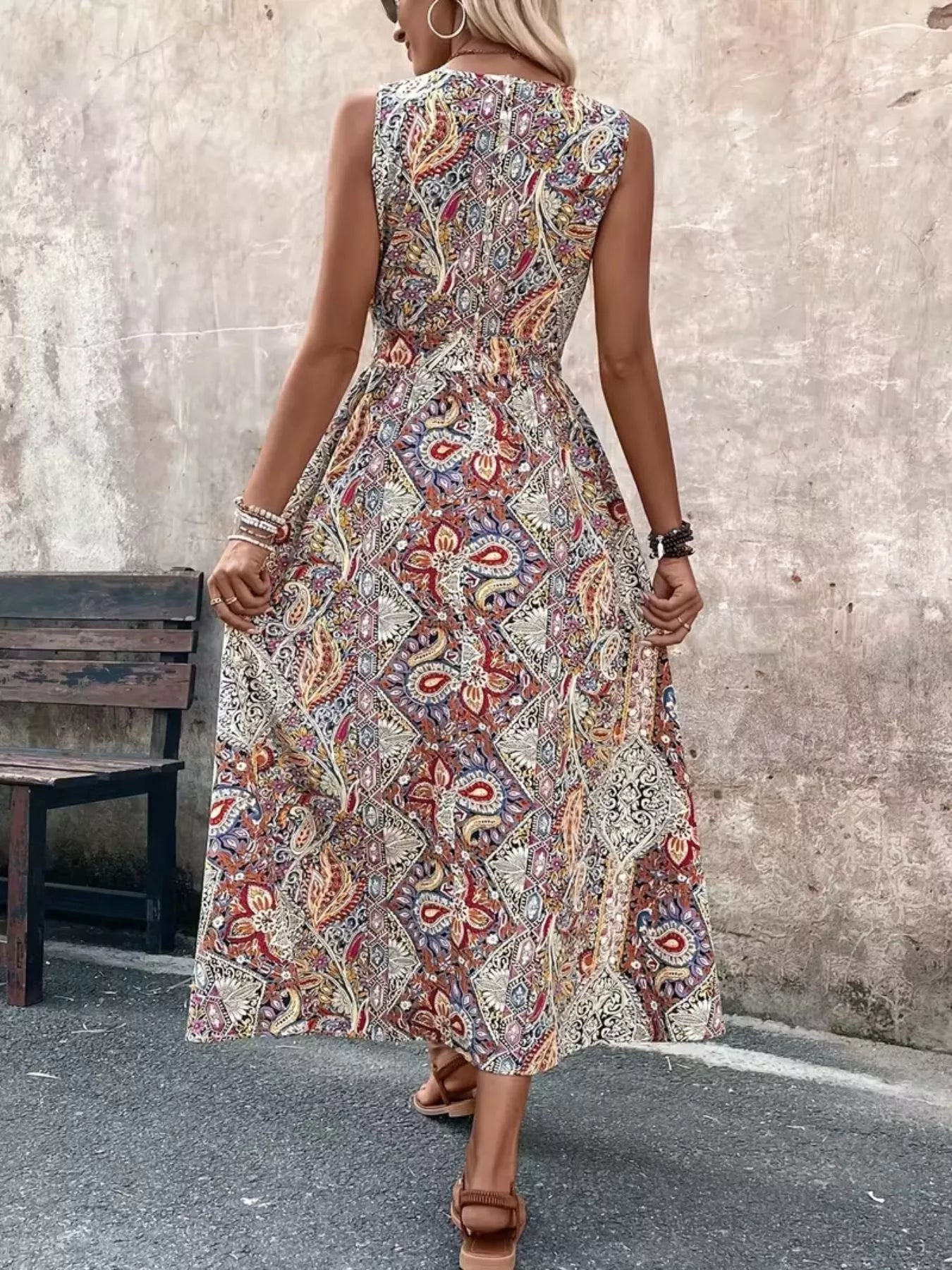 Back view of multicolor paisley sleeveless romper with long top, fitted waist seam