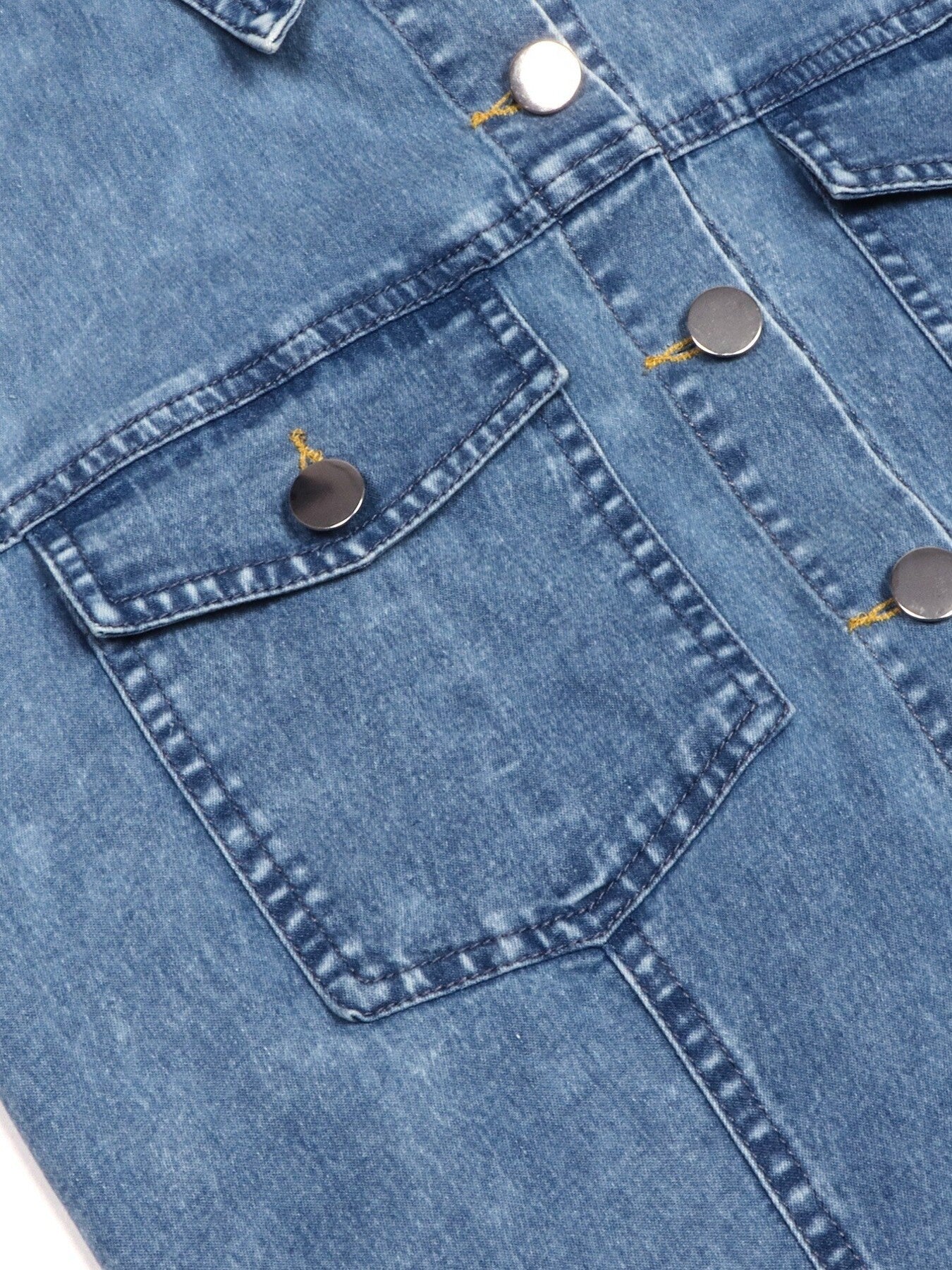 Light blue denim dress chest pocket with metal buttons and stitched details