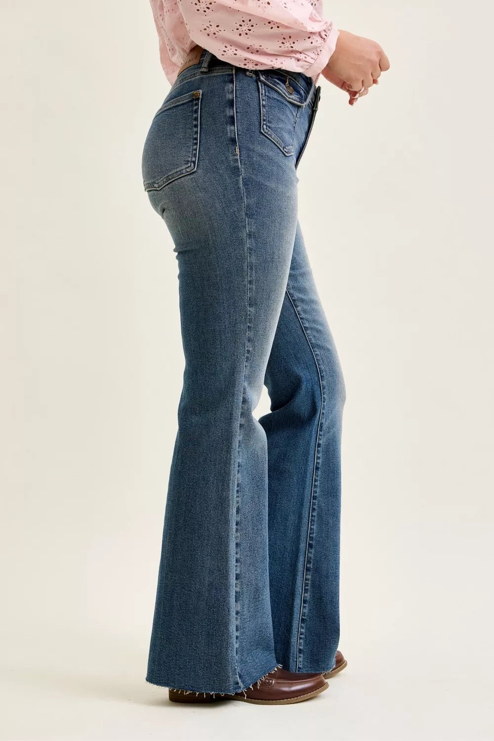 Dark wash mid-rise flare jeans with front flap pocket detail and wide bootcut hem