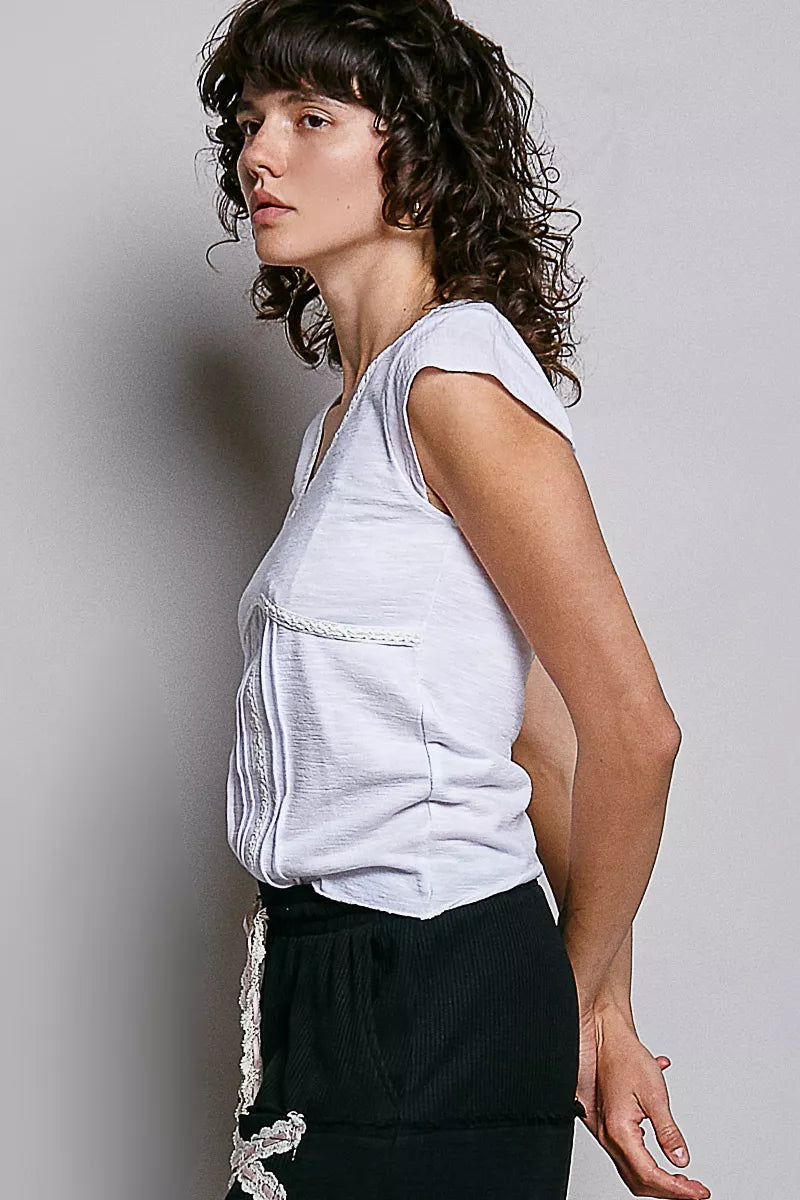 Off-white V-neck textured knit top with lace-trim neckline, side view