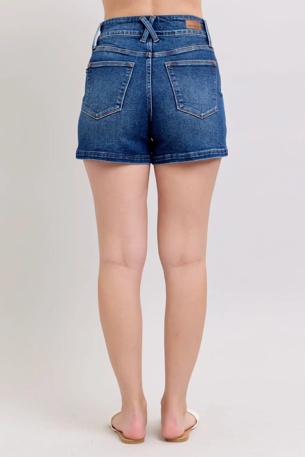 Dark denim shorts full back view with belt loops and two back pockets, straight hem