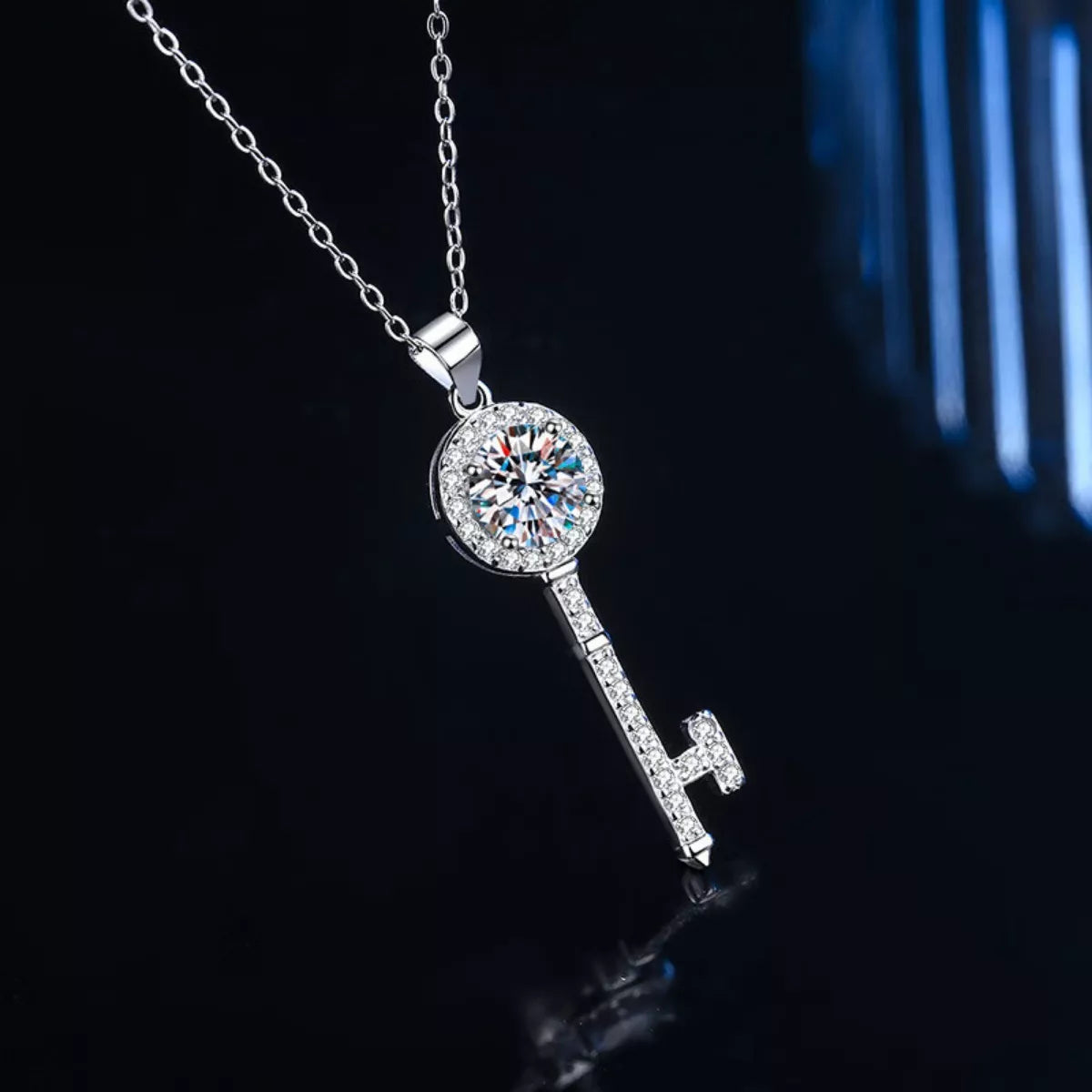 Moissanite key pendant necklace with round pavé halo and key drop on a silver chain