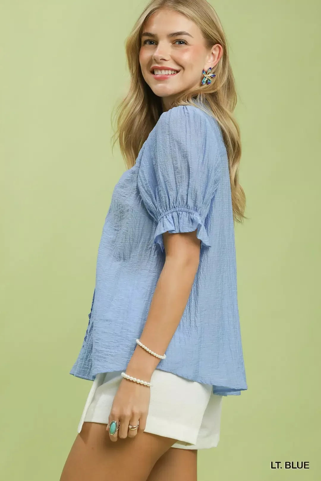 Light blue button-front V-neck puff sleeve blouse, side view