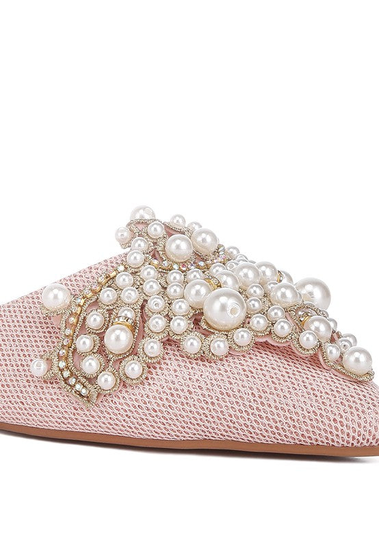 Blush mules with pearl clusters and gold-tone trim along the toe strap