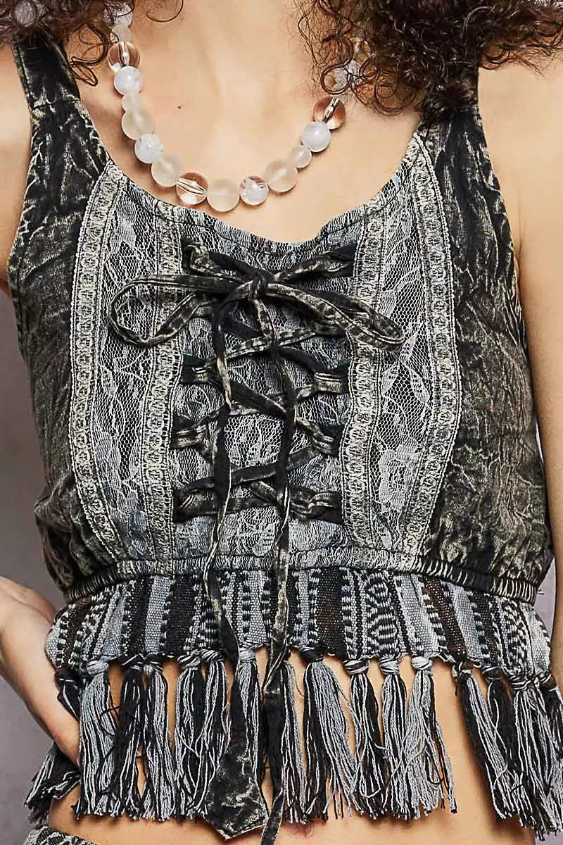 Close-up: charcoal lace-up fringe hem tank with tied lacing and textured lace fabric